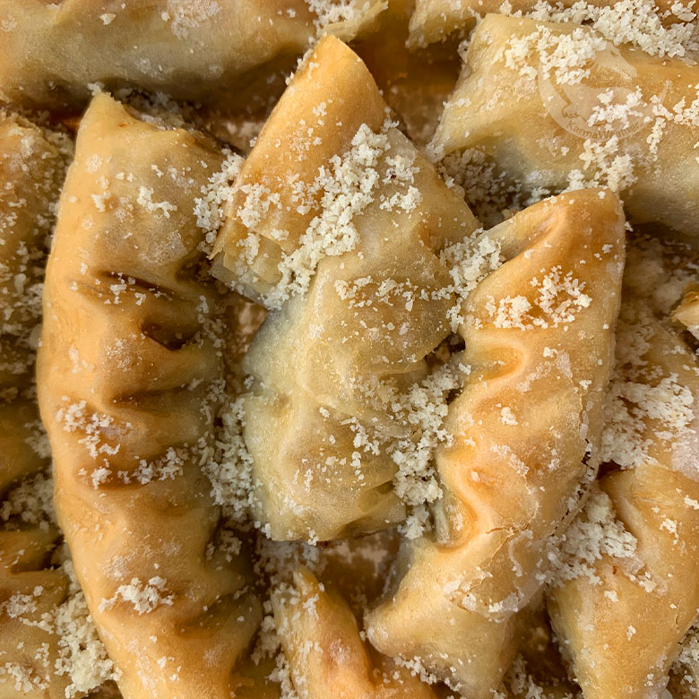 Baklava rolls sprinkled with almond powder