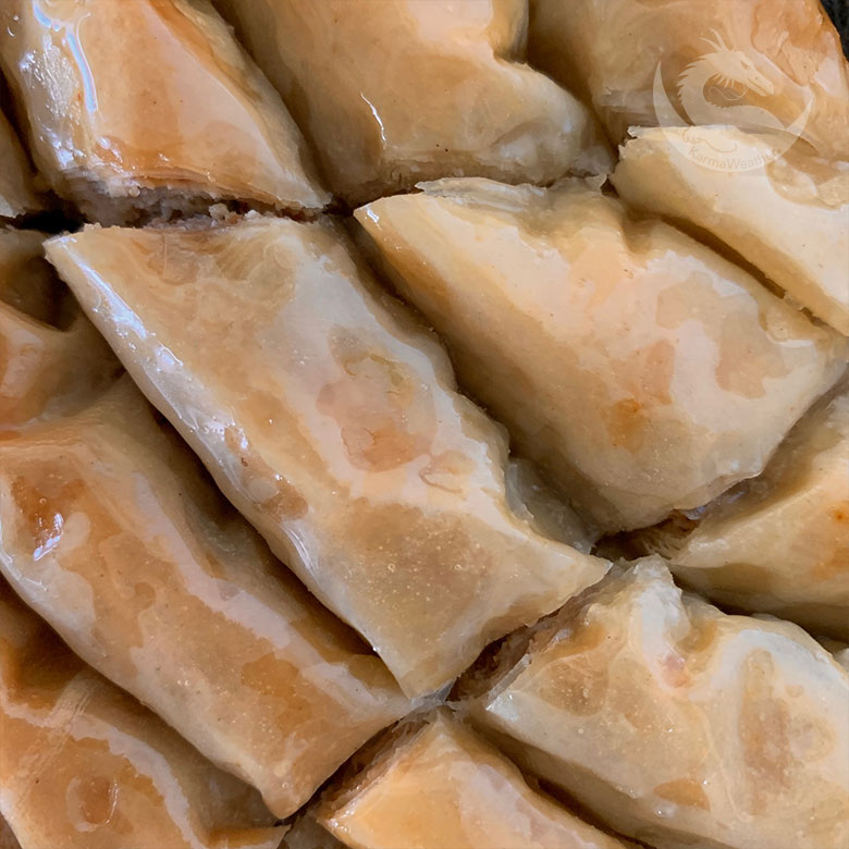 Cooked baklava rolls with syrup